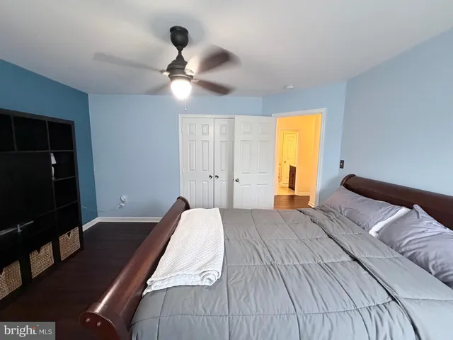 a view of a patio with couches and table and chairs with wooden floor