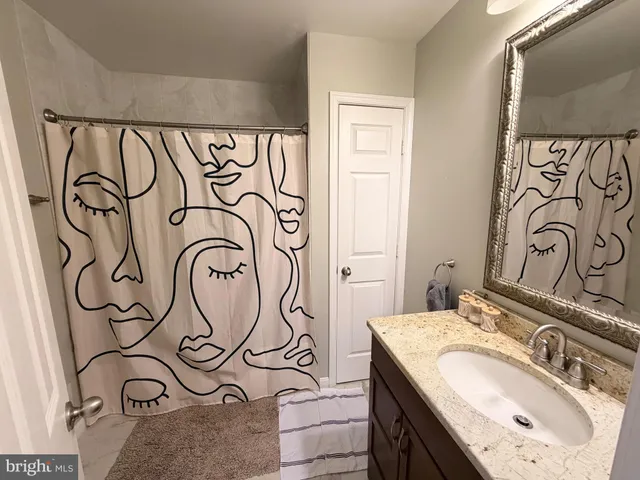 a view of a tiny house with a yard and large trees