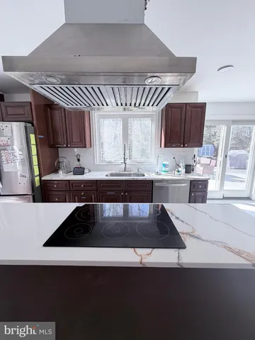 a kitchen with a sink a stove and cabinets