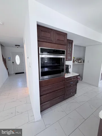 a kitchen with granite countertop a stove and a microwave