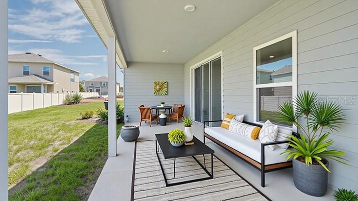 4281 Southwest 52nd Lane Road Ocala, FL 34474 - Photo 11 of 24 a living room with patio furniture and a patio