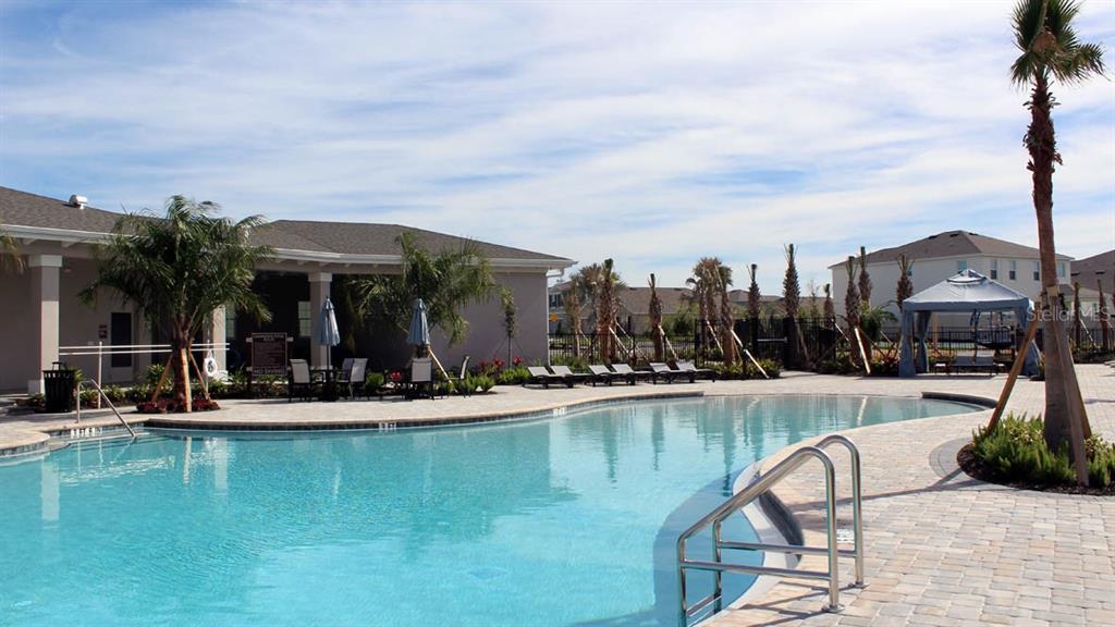 4281 Southwest 52nd Lane Road Ocala, FL 34474 - Photo 19 of 24 a view of a swimming pool with a lounge chairs