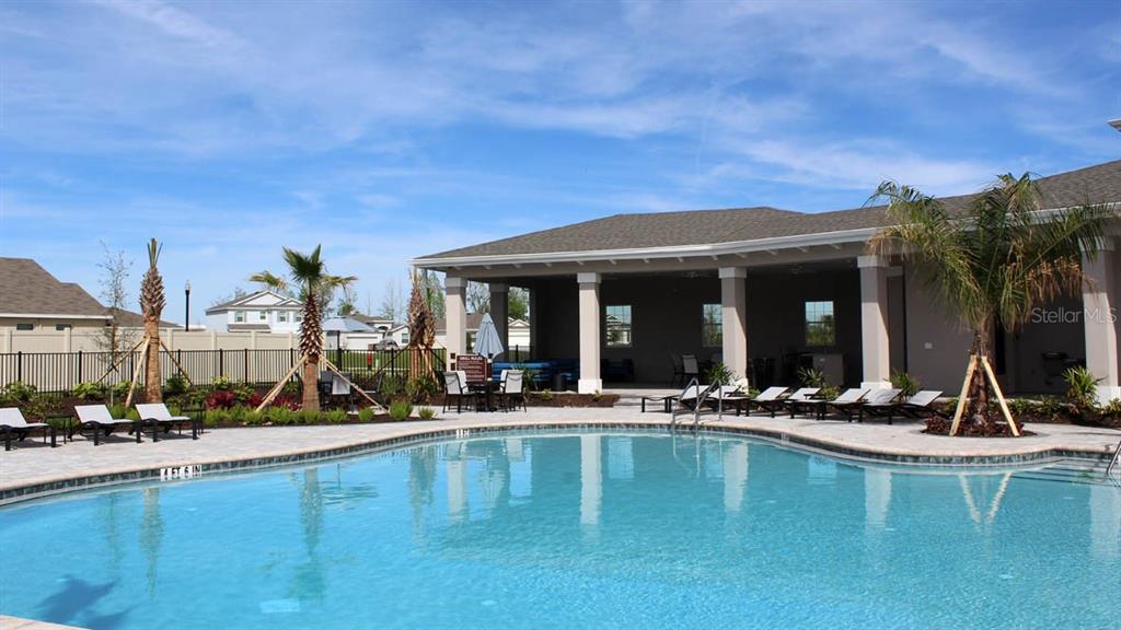 4281 Southwest 52nd Lane Road Ocala, FL 34474 - Photo 21 of 24 a view of a patio with swimming pool table and chairs