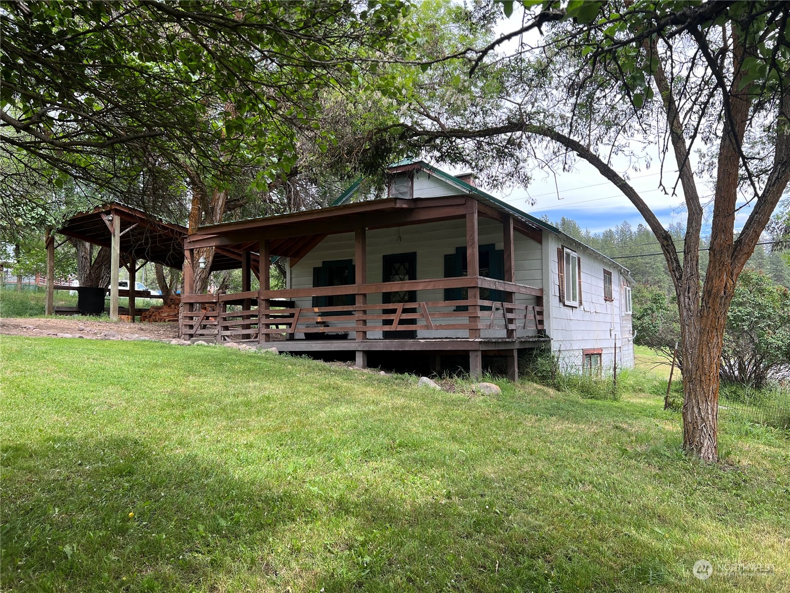 50 Klondike Road Republic, WA 99166 - Photo 18 of 18 a front view of a house with garden and trees
