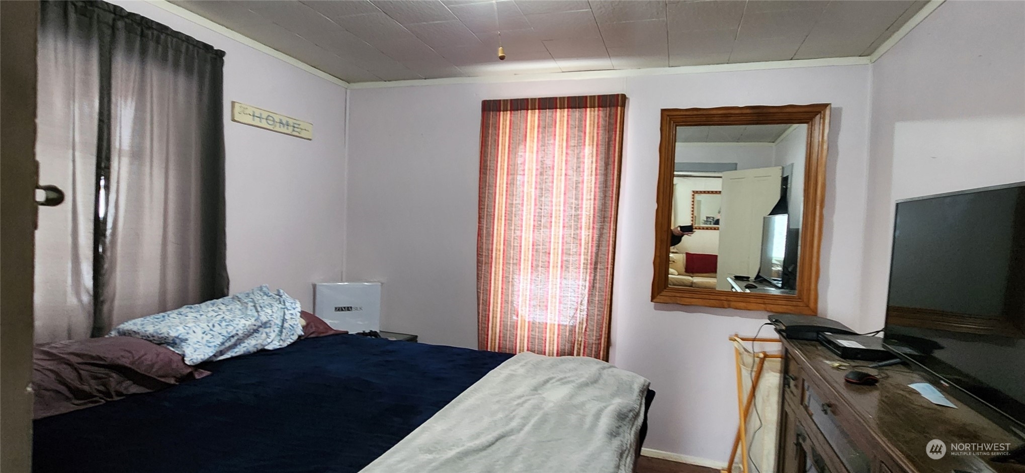 50 Klondike Road Republic, WA 99166 - Photo 6 of 18 a bedroom with a bed and a flat tv screen on a dresser