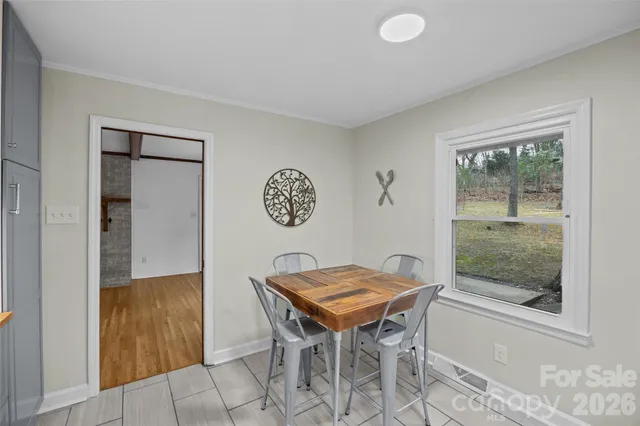 a living room with furniture a clock and a fireplace