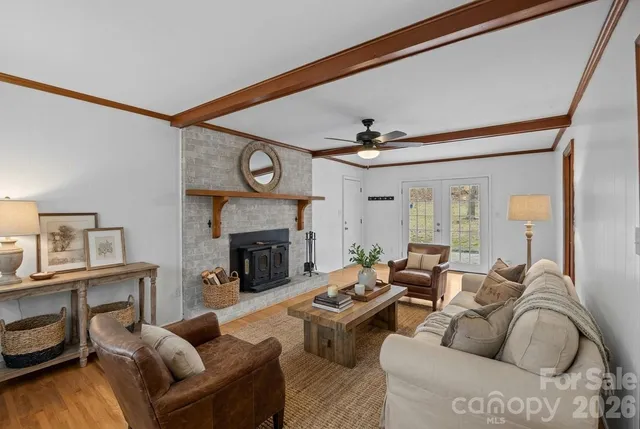 a living room with a fireplace and a ceiling fan