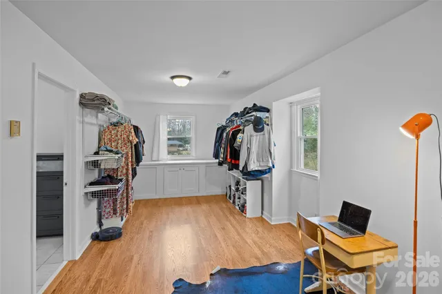 a view of walk in closet with clothes and shoes
