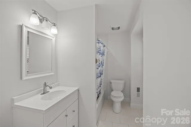 a bathroom with a toilet sink and a mirror