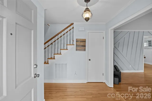 a view of a hallway view with wooden floor and staircase