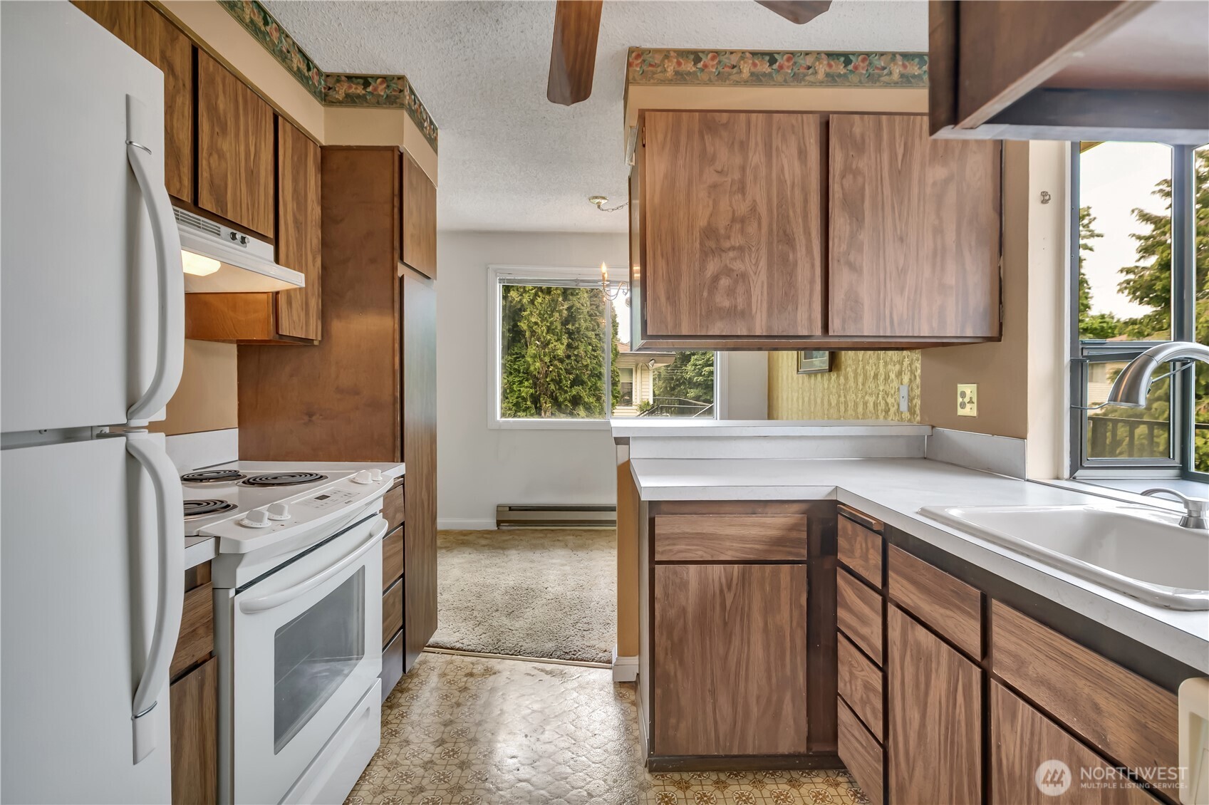 412 213th Place Southwest, Unit 21D Bothell, WA 98021 - Photo 17 of 28 a kitchen with a sink stove and cabinets