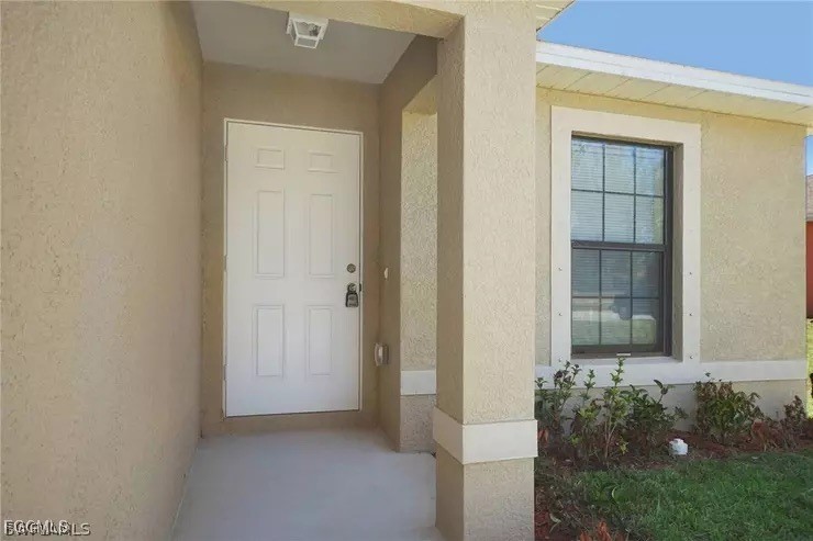 1114 Southwest 15th Place Cape Coral, FL 33991 - Photo 2 of 10 a view of a house with backyard