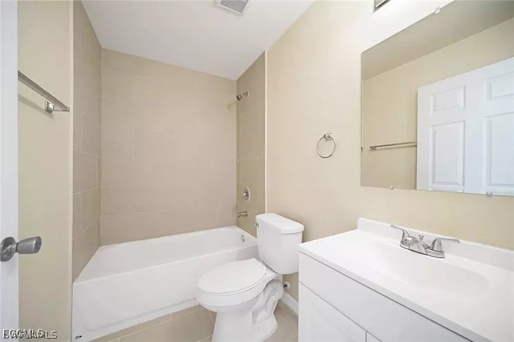 1114 Southwest 15th Place Cape Coral, FL 33991 - Photo 5 of 10 a bathroom with a sink toilet vanity and bathtub