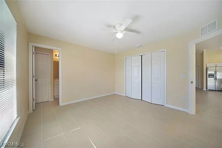 1114 Southwest 15th Place Cape Coral, FL 33991 - Photo 8 of 10 a view of an empty room with a ceiling fan