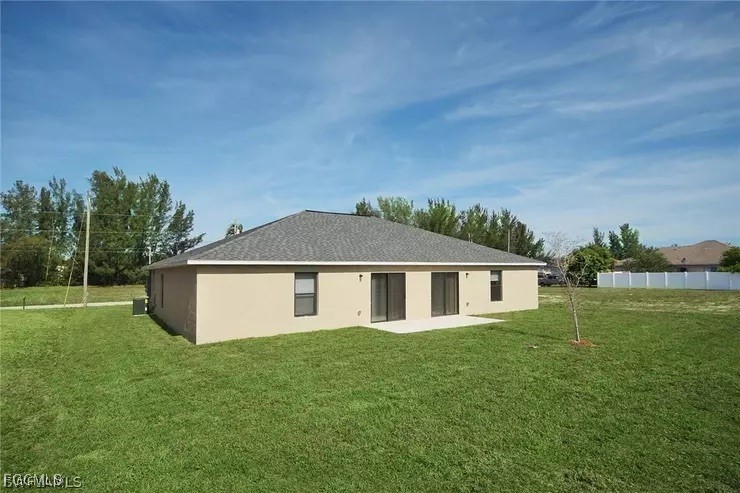 1114 Southwest 15th Place Cape Coral, FL 33991 - Photo 10 of 10 a front view of a house with a garden