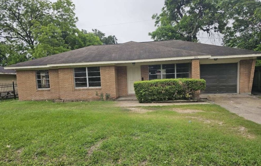 a view of a house with a yard and potted plants