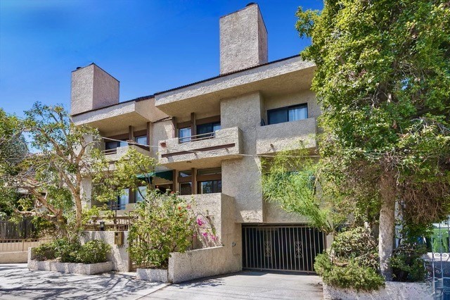a front view of a house with trees