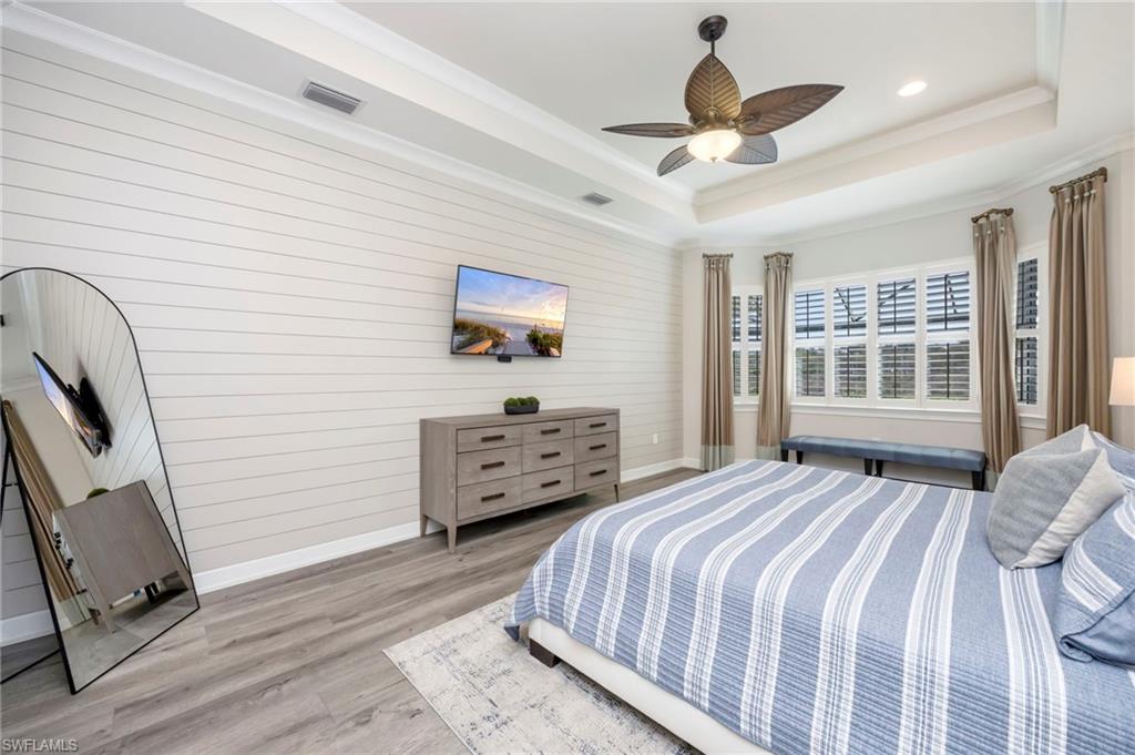 6466 Warwick Avenue Naples, FL 34113 - Photo 11 of 43 a bedroom with a bed and a large window