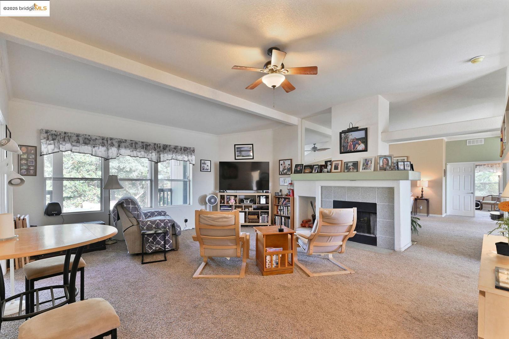 3770 Sheep Ranch Road Murphys, CA 95247 - Photo 11 of 60 a living room with furniture a fireplace and a large window