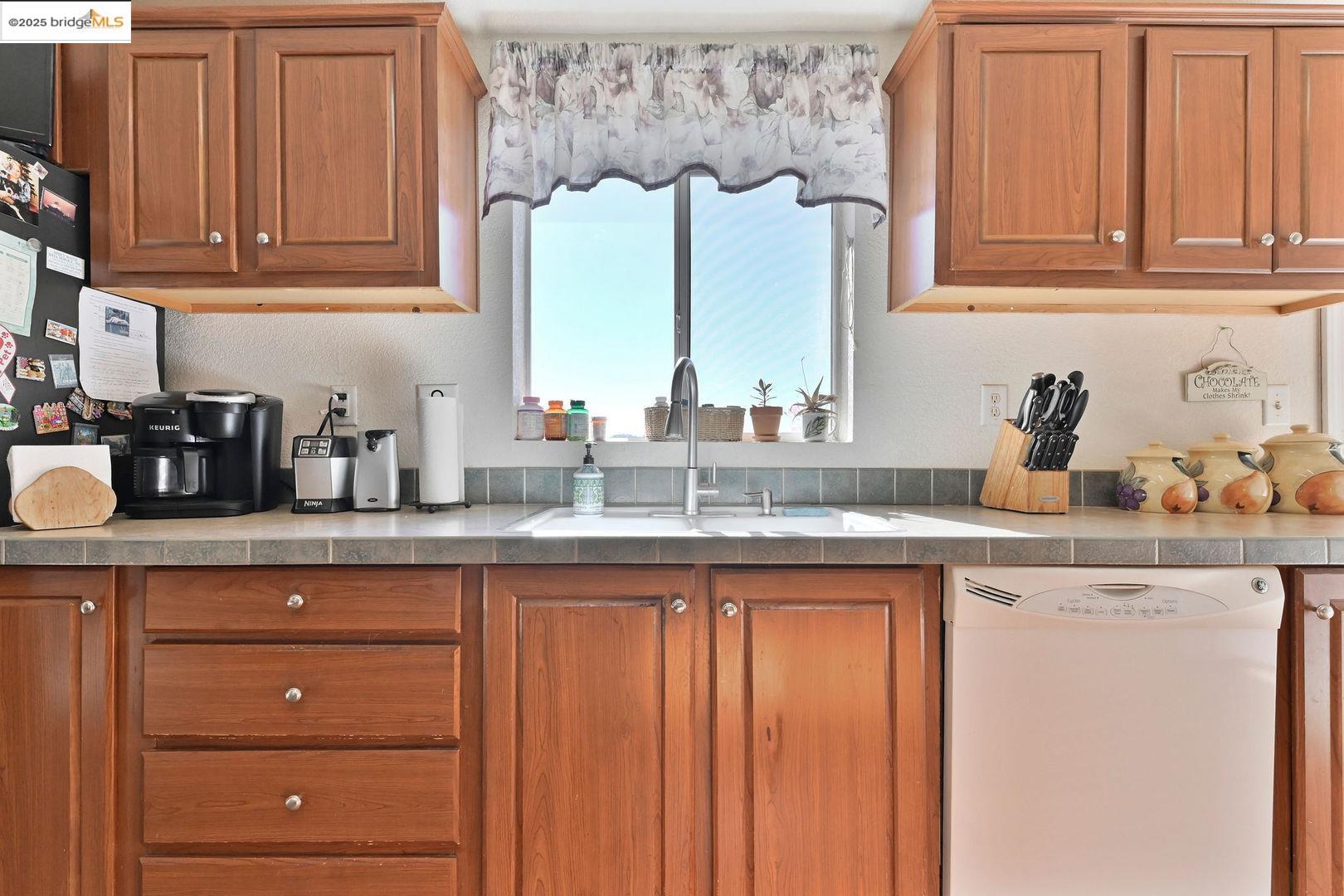 3770 Sheep Ranch Road Murphys, CA 95247 - Photo 16 of 60 a kitchen with granite countertop wooden cabinets and a sink