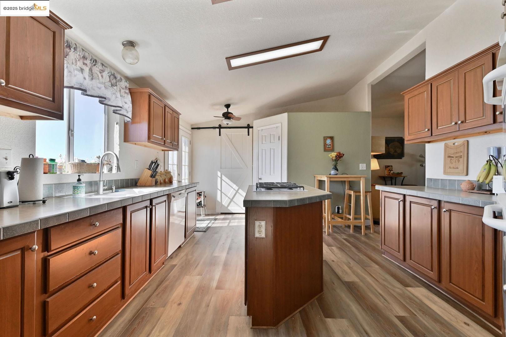 3770 Sheep Ranch Road Murphys, CA 95247 - Photo 18 of 60 a kitchen with granite countertop a sink appliances cabinets and furniture