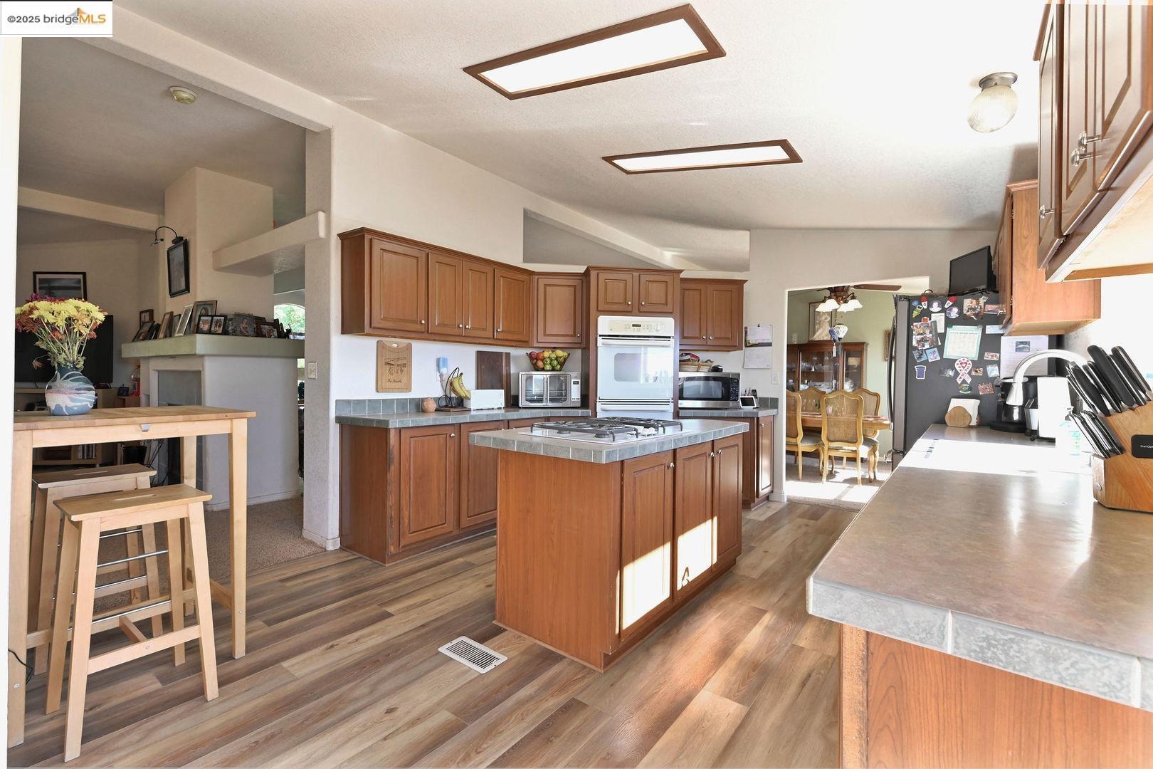 3770 Sheep Ranch Road Murphys, CA 95247 - Photo 22 of 60 a kitchen with stainless steel appliances granite countertop a refrigerator a stove and a sink