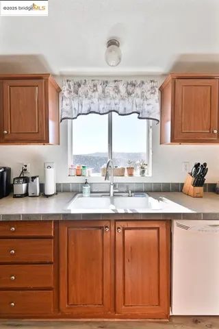 a kitchen with stainless steel appliances granite countertop a refrigerator a stove a sink and a cabinets