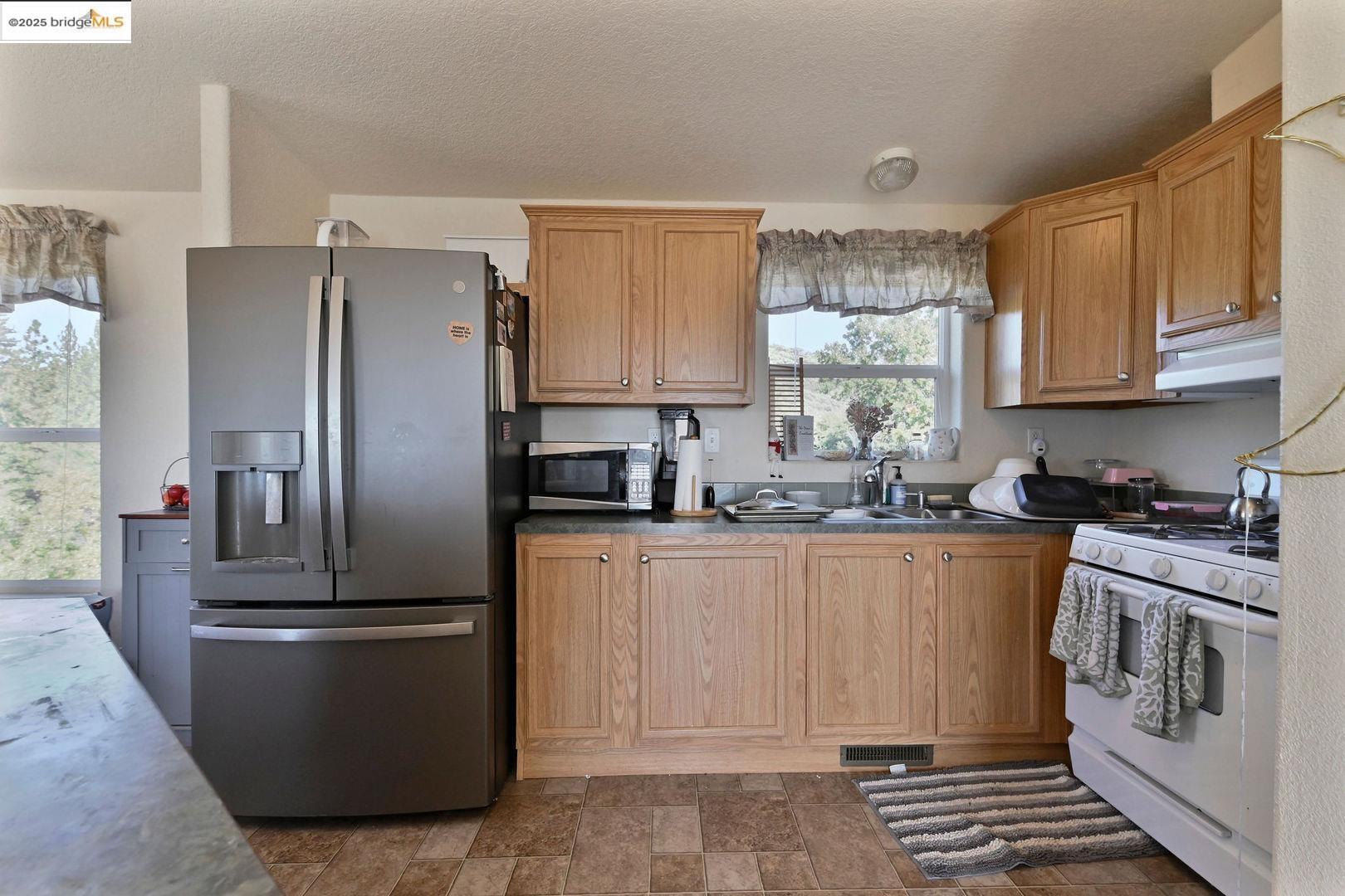 3770 Sheep Ranch Road Murphys, CA 95247 - Photo 29 of 60 a kitchen with stainless steel appliances granite countertop a refrigerator a stove a sink and a cabinets