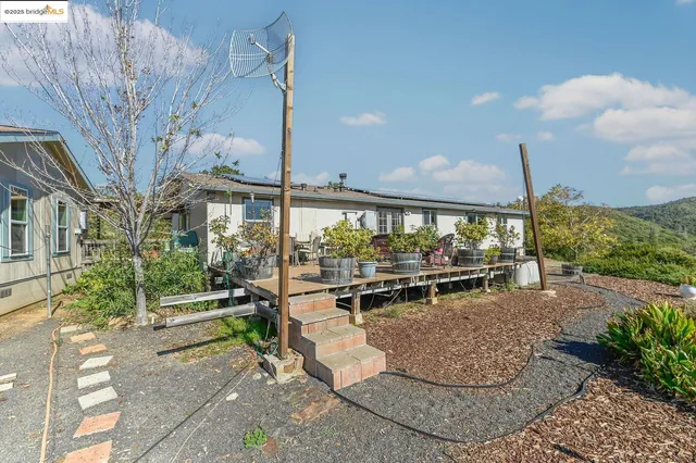 an aerial view of a house with a yard basket ball court and outdoor seating