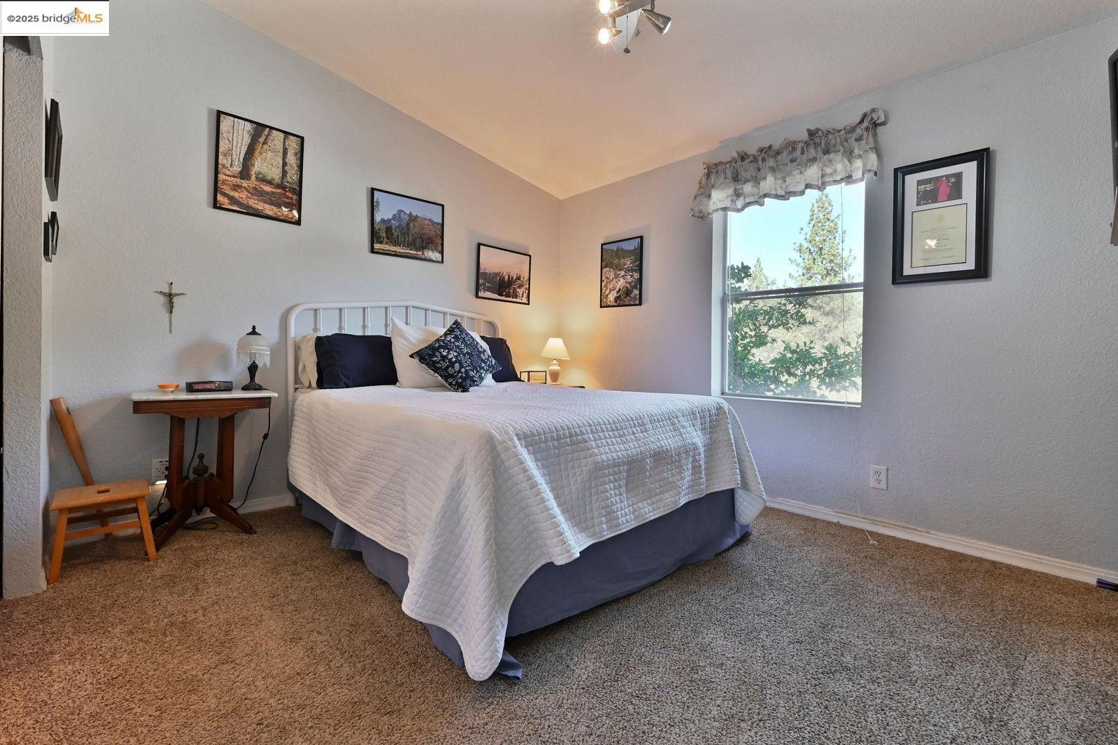 3770 Sheep Ranch Road Murphys, CA 95247 - Photo 6 of 60 a bedroom with a bed and a table in it