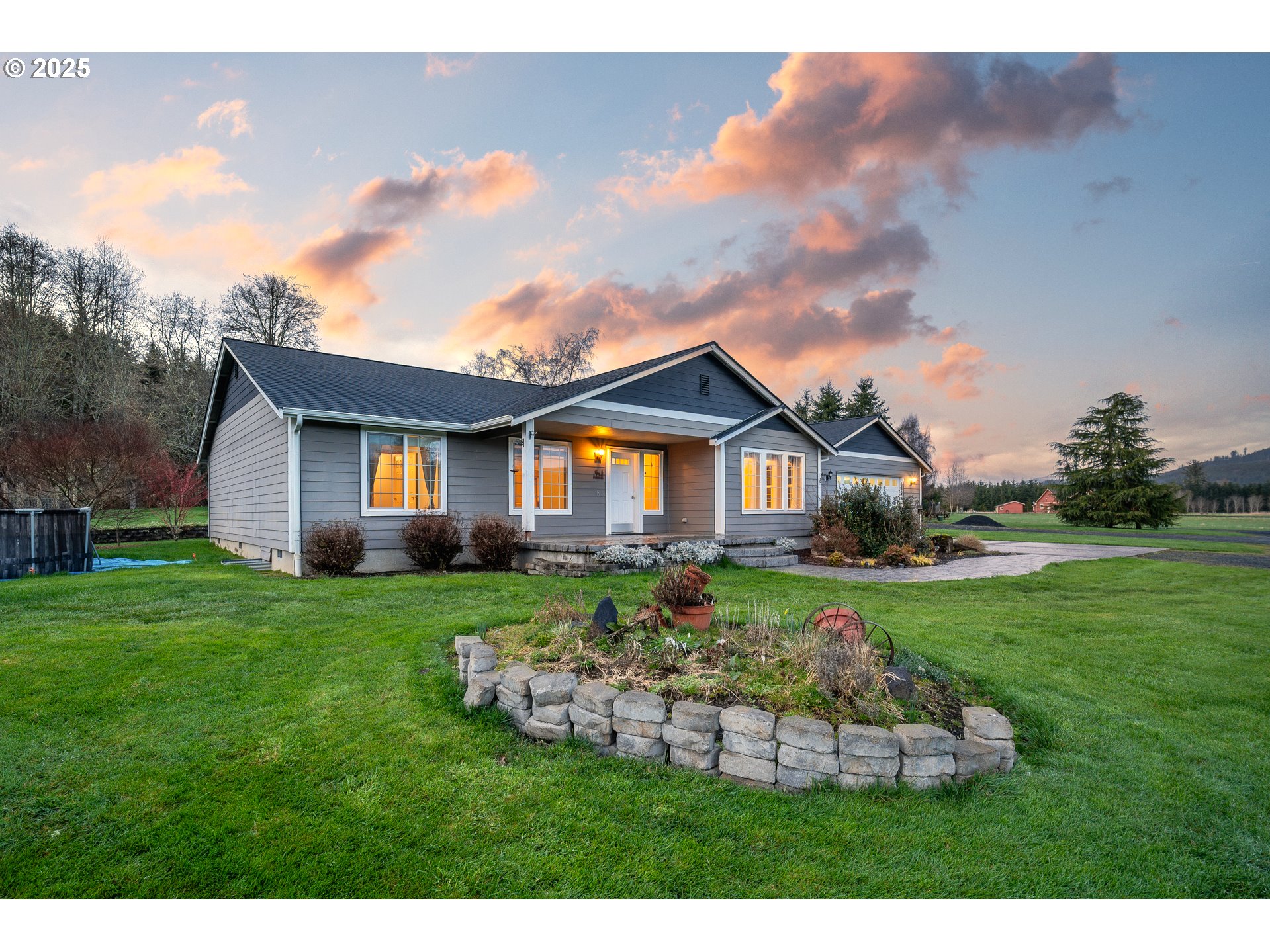 23 Elk Ridge Drive Cathlamet, WA 98612 - Photo 36 of 46 a front view of a house with a yard table and chairs