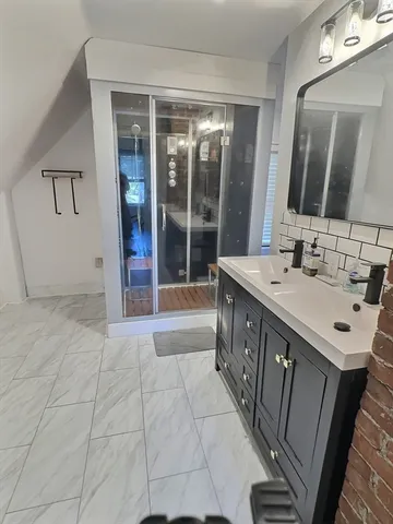 a bathroom with a sink a mirror and a shower