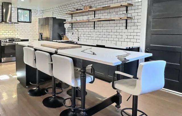 a dining room with chairs and wooden floor