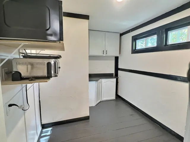 a kitchen with a refrigerator and a stove