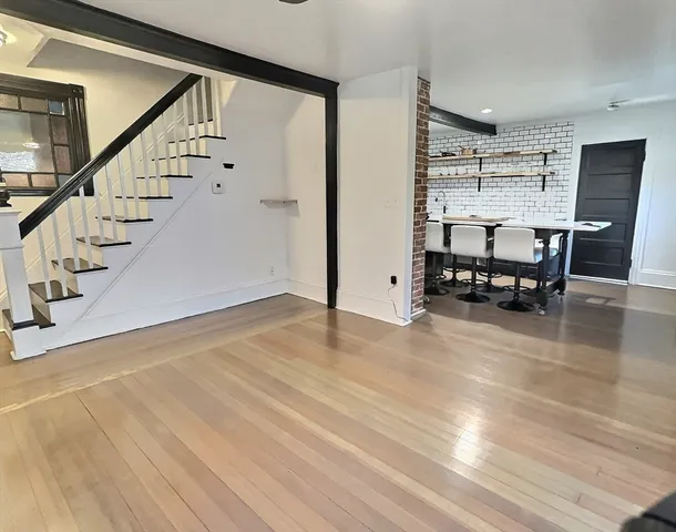 a view of a livingroom with furniture and an empty room
