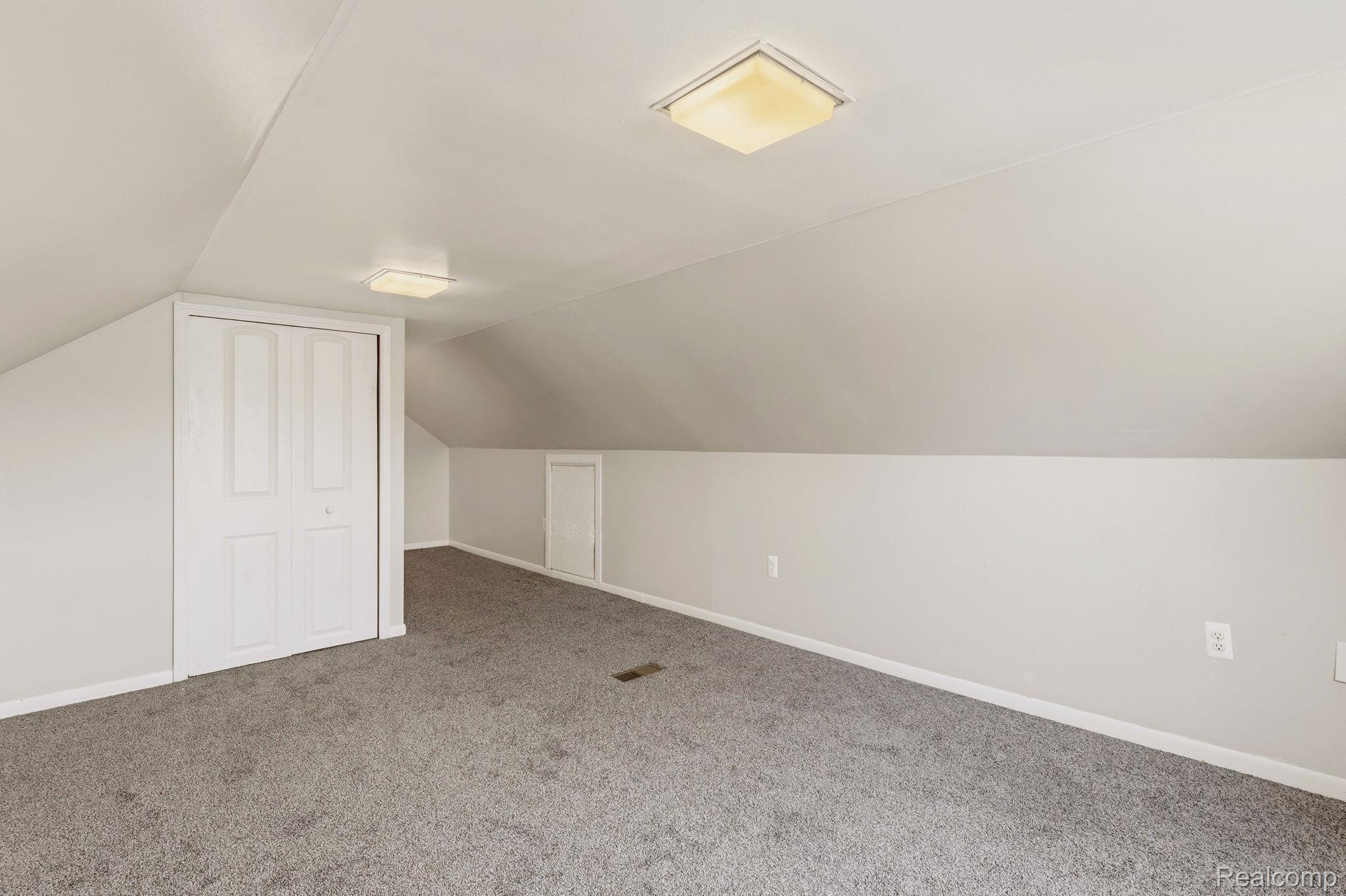 5852 Beech Daly Road Taylor, MI 48180 - Photo 19 of 29 Carpeted room featuring sloped ceilings and light wall paint