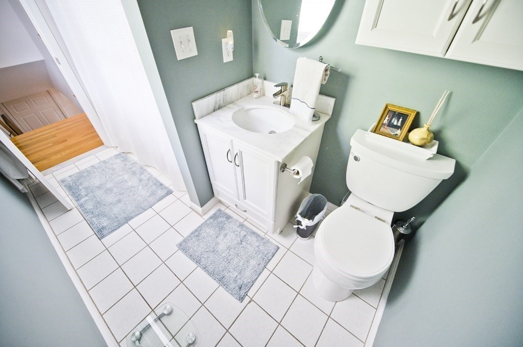 16 Warren Avenue Newton, MA 02465 - Photo 41 of 42 a bathroom with a sink mirror and toilet