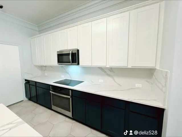a kitchen with stainless steel appliances granite countertop a sink and a microwave