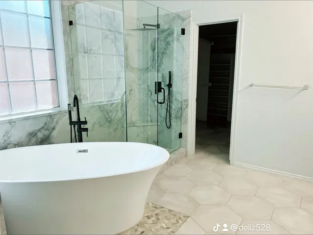 a bathroom with a bathtub and shower
