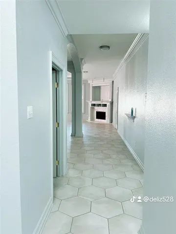 a view of a kitchen with a sink and a refrigerator