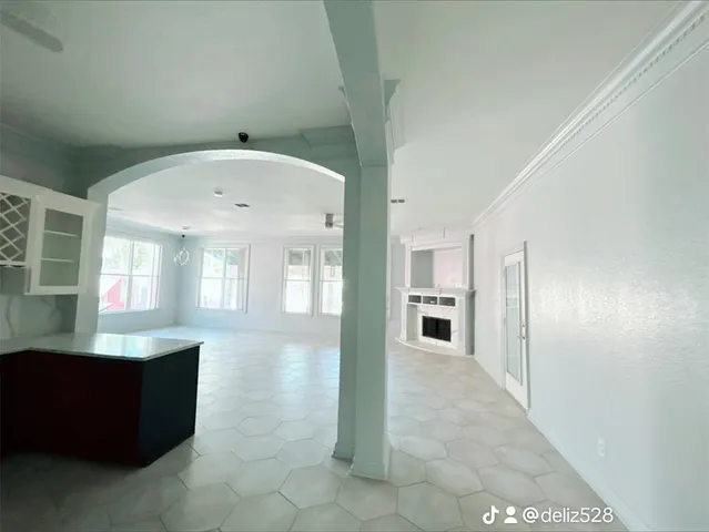 a spacious bathroom with a granite countertop sink a mirror and window