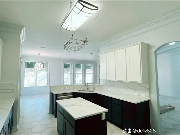 a kitchen with a sink refrigerator and cabinets