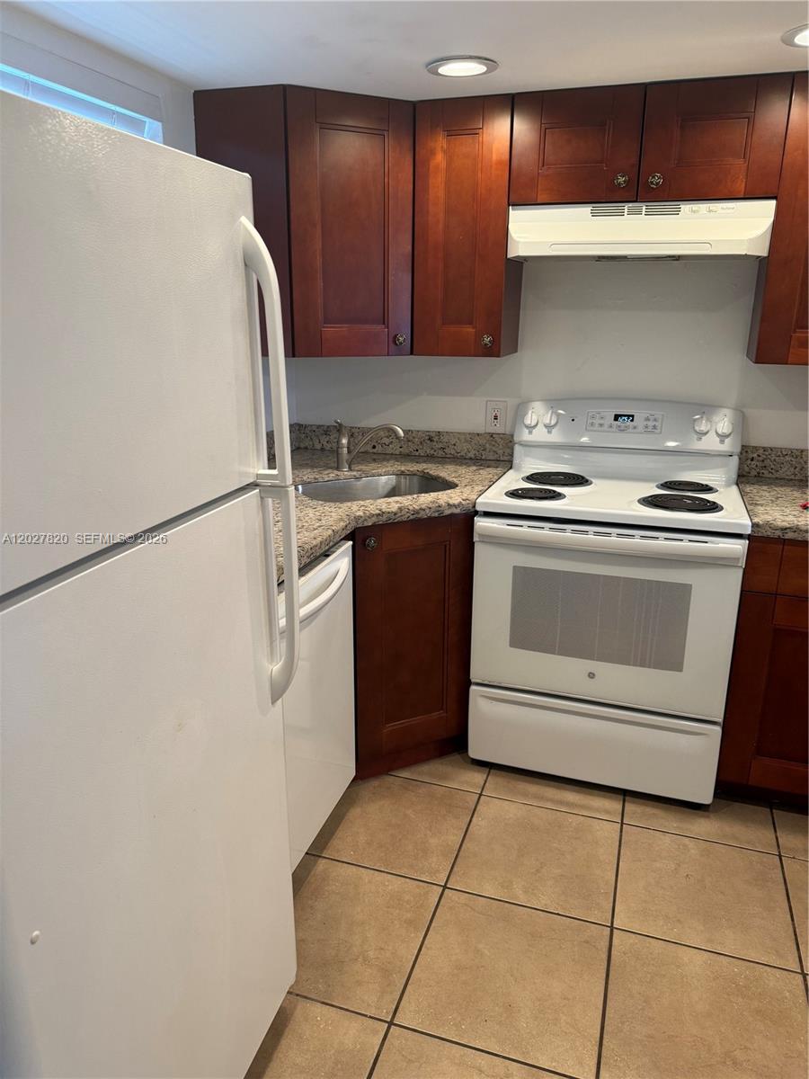 6841 Pembroke Road, Unit 15 Pembroke Pines, FL 33023 - Photo 6 of 16 a white stove top oven sitting inside of a kitchen