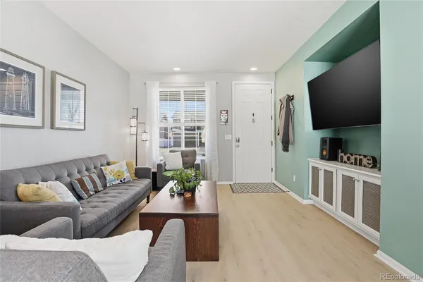 a living room with furniture and a flat screen tv