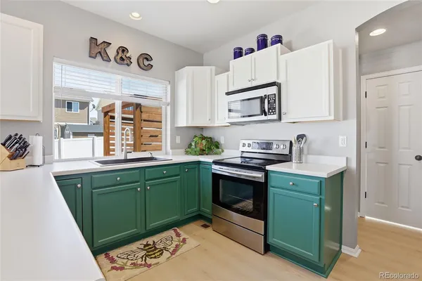 a kitchen with sink and cabinets