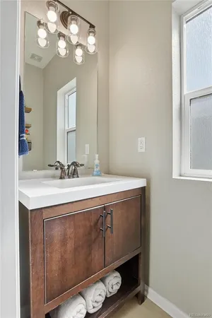 a bathroom with a sink vanity and a mirror
