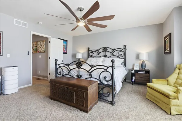 a bedroom with furniture and a ceiling fan