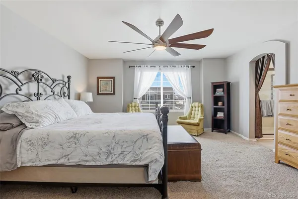 a bedroom with a bed and a large window