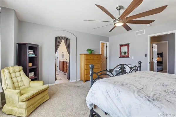 a bedroom with a bed a couch and dresser