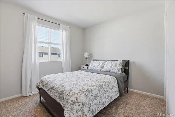 a bedroom with a bed and window